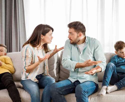 Modern children portrait - boys on their phones, while none is paying attention to their parents arguing